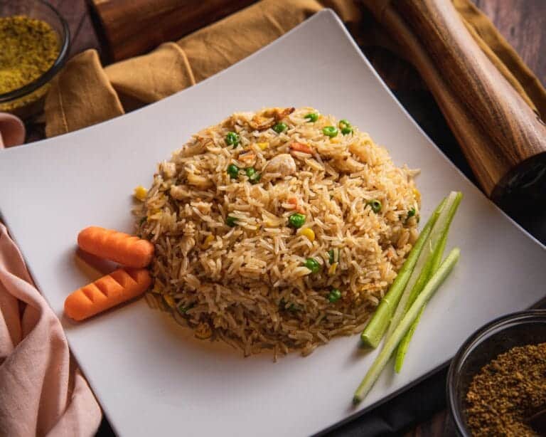 High-protein chicken and egg fried rice with spring onions in a wok